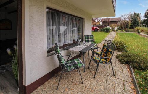 a patio with two chairs and a table on a house at 2 Bedroom Beautiful Apartment In Arrach in Arrach