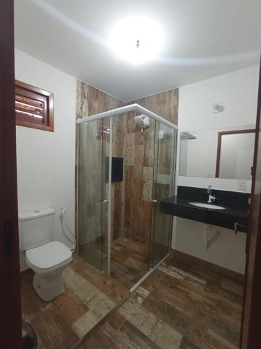 a bathroom with a shower and a toilet and a sink at Casa Bete e Farouk in São Miguel do Gostoso