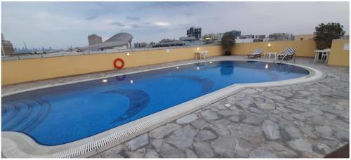 a swimming pool on the roof of a building at Akas-Inn Hotel Apartment in Dubai