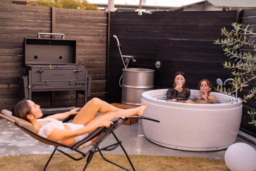 two women laying in chairs in a hot tub at IZA近江舞子 in Minami-komatsu