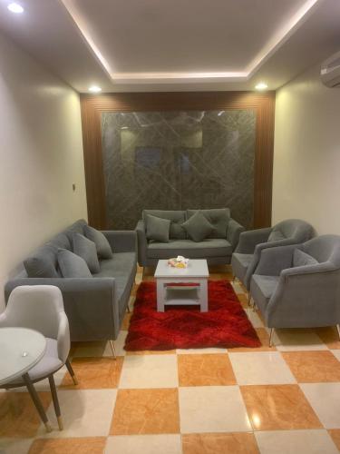 a living room with couches and a coffee table at Orchid Tarif Serviced Apartments 1 شقق أوركيد طريف للشقق المخدومة 1 in Ţurayf