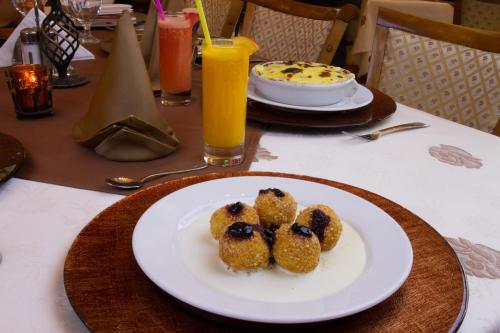 a plate with three blueberry muffins on a table at Vila Preciosa in Alba Iulia