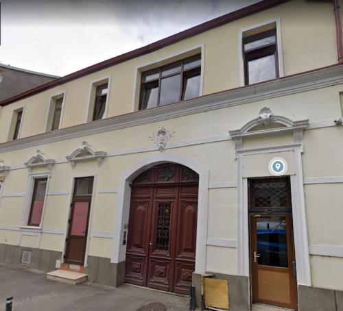 a building with two brown doors and a building at The Dom 21 in Cluj-Napoca