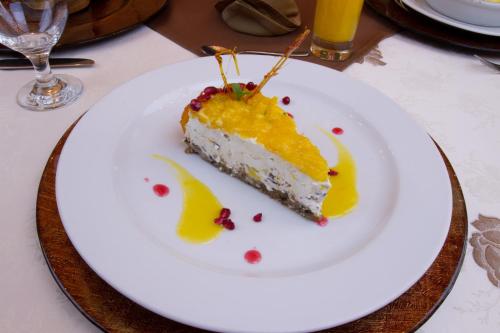 a piece of cake on a white plate on a table at Vila Preciosa in Alba Iulia