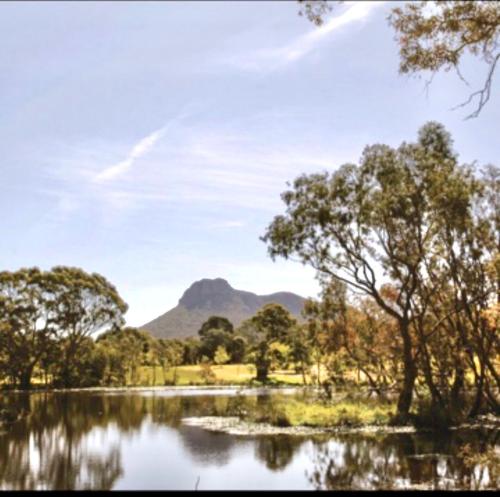 a lake with trees and mountains in the background at #Grampians Views Getaway #CBD #Netflix in Stawell