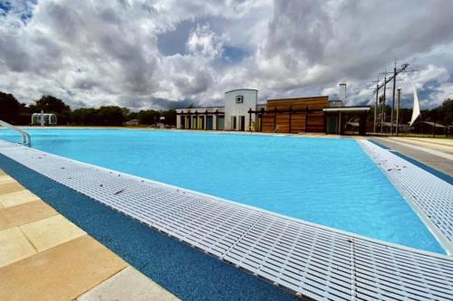 a large blue swimming pool on top of a building at The Wardens Hideaway - Tattershall Lakes Country Park in Tattershall