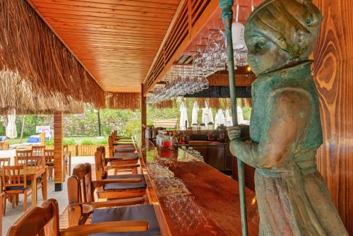 a statue of a woman sitting at a table in a restaurant at Doria Hotel Yacht Club Kaş in Kaş