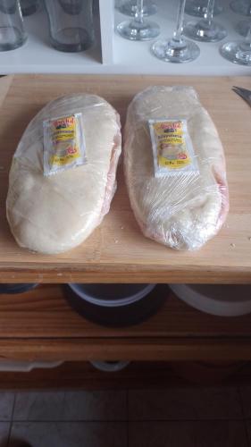 two bags of meat sitting on a wooden shelf at Hotel Lago del Desierto in El Chalten
