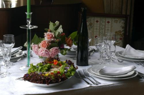 a table with a white table cloth with a bowl of food at Palazzetto Ardi in Torri di Confine