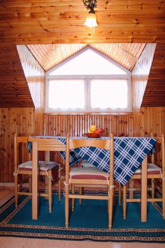 a table and chairs in a room with a window at Diana Guesthouse in Korçë