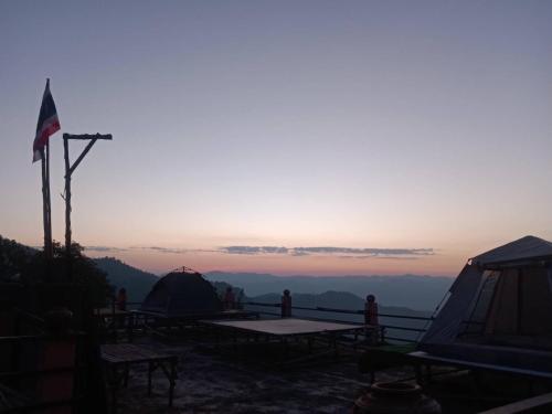 a group of tents on top of a mountain at sunset at Terre Terrace Glamping - Doichang in Ban Huai Khai