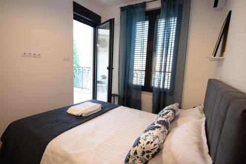 a bedroom with a bed and a window at Apartman Mango & Mia in Trebinje