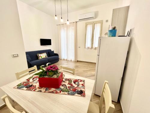 a kitchen and living room with a table and a refrigerator at Ciuri di Sicilia in Capaci