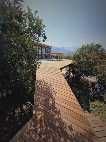 a wooden walkway with a house on top of it at El Violin Experiencia Adults only in Melegis