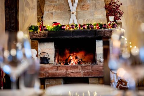 a fireplace with fruits and vegetables on top of it at Velinov Boutique Hotel in Bansko