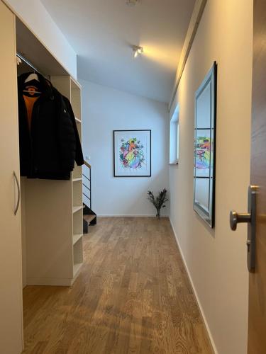a hallway with white walls and a hallway with a door at Haus Wiesenquelle, Deluxe-Apartment 'Feld & Berg' in Feldberg