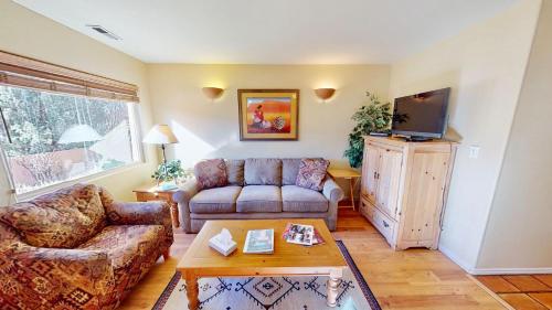 a living room with a couch and a tv at Kokopelli's Kiva #3230 in Moab