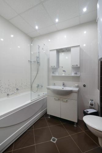 a bathroom with a tub and a sink and a shower at Infinity View Shkorpilovci in Shkorpilovtsi