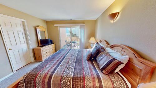 a bedroom with a bed and a dresser and a mirror at Kokopelli's Kiva #3230 in Moab