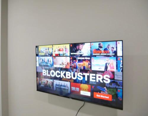 a flat screen television hanging on a wall at Atria SOFO Suites By Stay In in Petaling Jaya
