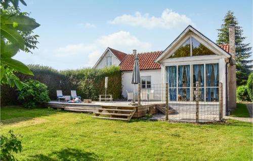 a house with a deck and a patio at 2 Bedroom Beautiful Home In Smedstorp in Smedstorp