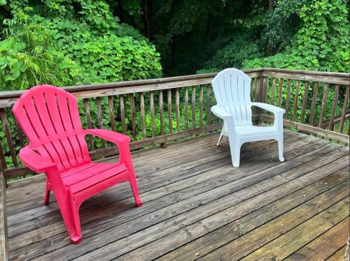 two chairs sitting on top of a wooden deck at Homey Townhouse Near Lake & Sports Complex in Guntersville