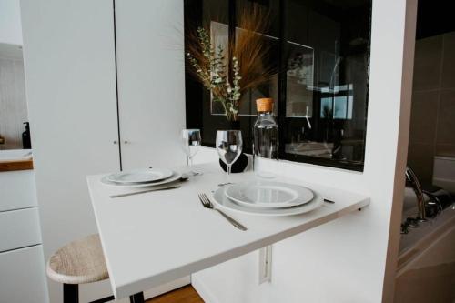 un tavolo con piatti e bicchieri da vino su un bancone di Sweet Love Room - Jacuzzi Privatif a Montreuil