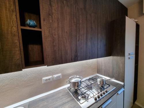 a kitchen with a stove with two pots on it at Residenza Azzurra in Cattolica