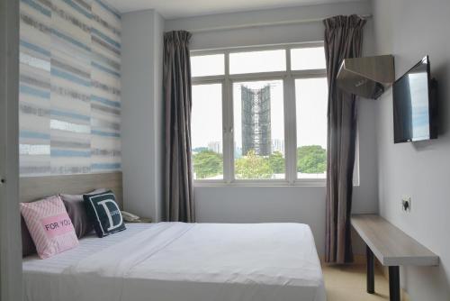 a bedroom with a bed and a large window at DUTA HOTEL in Kuala Lumpur