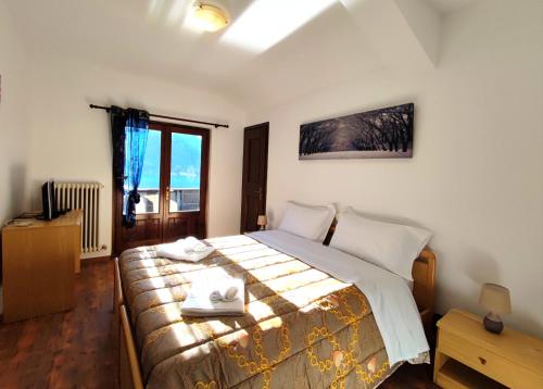 Postel nebo postele na pokoji v ubytování Hotel TEA DOLOMITI - Lago di Alleghe - Monte Civetta