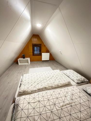 a bedroom with two beds in a attic at KOTA - Prime Location in Jahorina