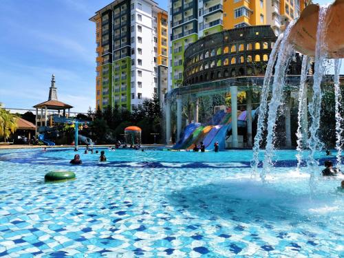 a swimming pool with a fountain in a city at FREE 4 WATER THEMEPARK Tickets & WiFi Stay Melaka in Melaka