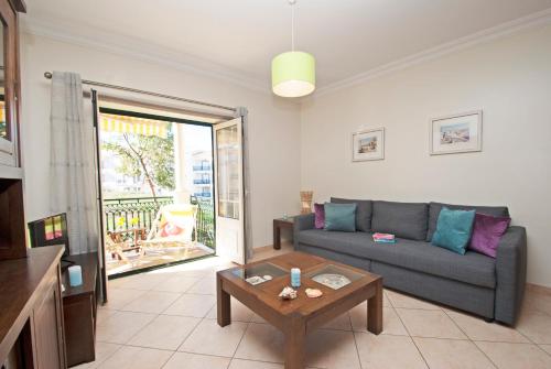 a living room with a couch and a table at Apartment Montego Bay by Algarve Vacation in Albufeira