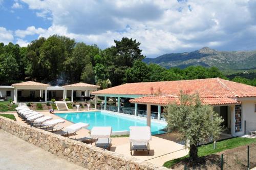 un complexe avec une piscine et des chaises longues dans l'établissement Cantu di Fiumu, à Zonza