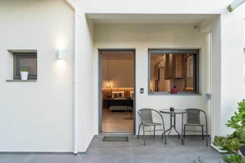a patio with chairs and a table in a house at Esperos Studios and Apartments, #2 in Stalida