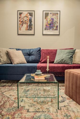 a living room with a couch and a glass table at Artemis Apartment Midas Home Project in Thessaloniki