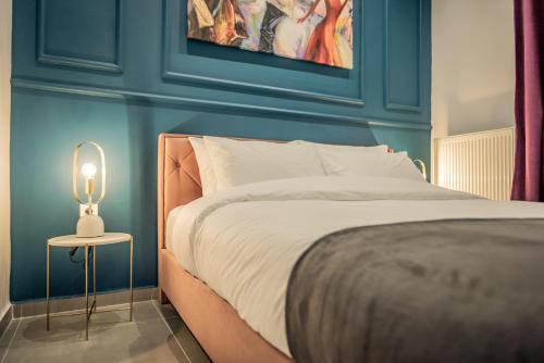 a bedroom with a bed and a table with a lamp at Artemis Apartment Midas Home Project in Thessaloniki