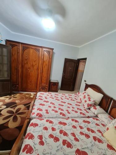 una camera da letto con un letto con una coperta a fiori rossi di SEMO Home a Il Cairo
