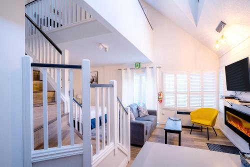 a living room with a staircase and a couch at Loft with a view of Blue - Free Wifi, Linens and Towels Included in Blue Mountains