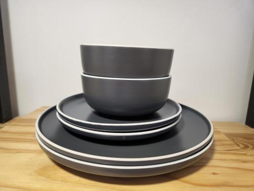 a stack of black plates sitting on a table at East Park Inn in Polokwane