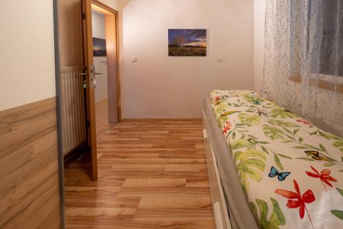 a bedroom with a bed and a door to a hallway at Ferienwohnung Ulla in Bad Staffelstein