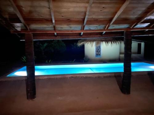 a swimming pool with blue lighting under a roof at Villa Idaka in Rufisque
