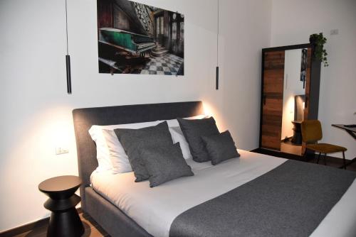 a bedroom with a bed and a table and a mirror at GL rooms and apartments in Bari