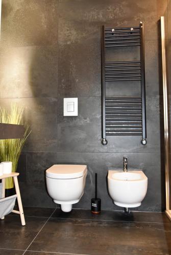 a bathroom with a toilet and a sink at GL rooms and apartments in Bari