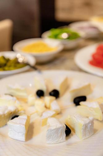 a plate of food with cheese on a table at Hotel Best Night 2 in Alger