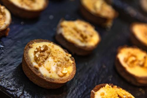 a close up of a muffin pan filled with food at Hotel Best Night 2 in Alger