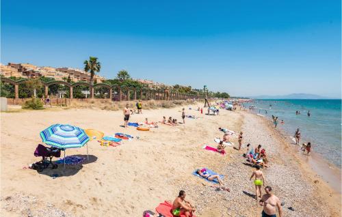 a group of people on a sandy beach at Stunning Apartment In Oropesa Del Mar in Oropesa del Mar