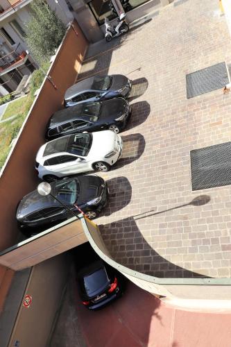 a row of cars parked on the side of a building at Hotel Domenichino in Milan