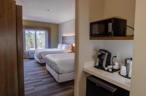 a hotel room with two beds and a television at Holiday Inn Express Hotel & Suites Atlanta Airport West - Camp Creek, an IHG Hotel in Atlanta