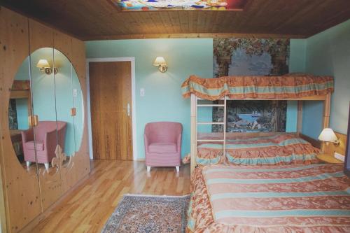 a bedroom with a canopy bed and a chair at Apartment "Gustav Klimt" in Zell am See